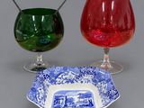two wine glasses and a plate with a blue and white design