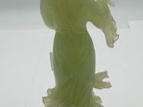 a statue of a woman holding a flower in her hand