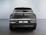 the rear end of a silver car in a white room