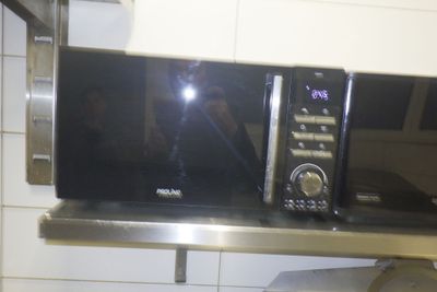 un micro-ondes posé sur une étagère dans une cuisine