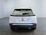 the rear end of a white car in a white room