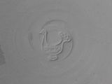 a white plate with a bird in the middle of it