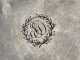the logo of a silver plate with a laurel wreath on top of it