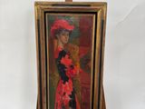 tableau représentant une femme coiffée d'un chapeau rouge, posé sur un chevalet en bois