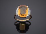 an orange sapphire and diamond ring