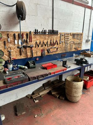 a workbench with many tools on it in a garage