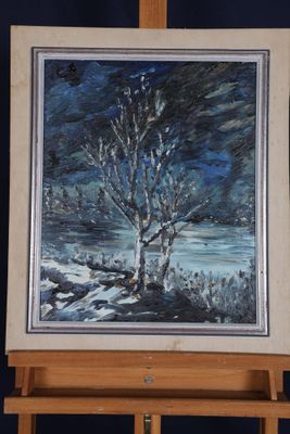 a painting of a tree on a easel in front of a dark blue background