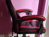 a red and black office chair in the corner of a room