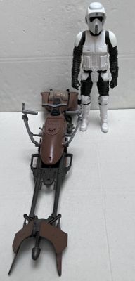 a toy figure of a stormtrooper standing next to a toy motorcycle