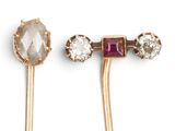 a pair of gold tone ear pins with crystal and stone accents