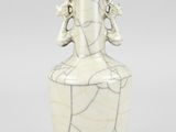 a white vase with a design on the top of it