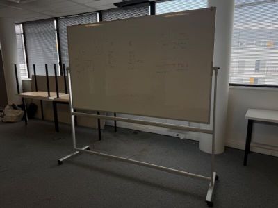 a white board in the middle of a room with a whiteboard on it