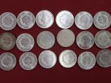 some silver coins are arranged on a red surface