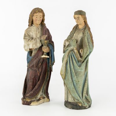 two figurines of jesus and mary holding a child