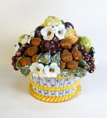 a vase with a bunch of fruits and nuts in it