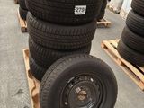 several tires are stacked on pallets in a warehouse area