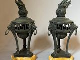 two bronze statues of a dragon on top of each other