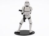 star wars figurine stormtrooper holding a gun on a white background