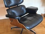 une photo d'un fauteuil et d'un repose-pieds en cuir noir dans un salon