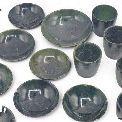 a lot of green dishes and cups on a white surface