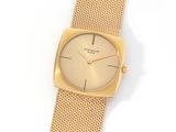 a close up of a gold watch on a white surface