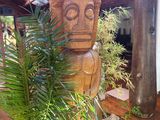 a wooden statue in the middle of a wooden floor