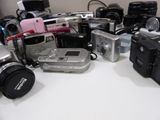 a lot of cameras that are sitting on a table