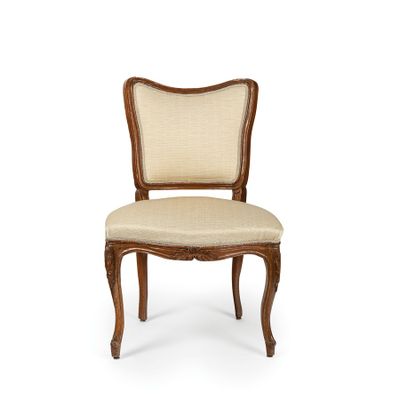 the back of a chair with a beige upholstered seat