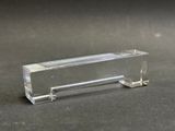 a clear glass object on a black surface