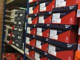 shelves with boxes of various sizes and colors in a store