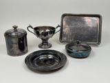 several pieces of silverware are sitting on a white surface