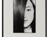 a black and white photo of a woman with long hair