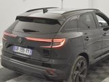 the rear end of a black car parked on a checkered floor