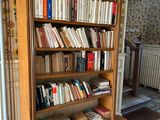 a bookshelf full of books in the corner of a room