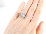 a woman ' s hand with a diamond ring on it