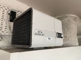 a small air conditioner sitting on top of a shelf