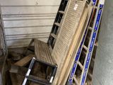 a pile of wood and a ladder in a garage
