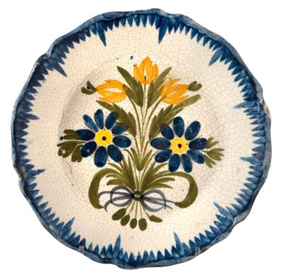 a blue and white plate with yellow flowers on it
