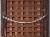 a close up of an old wooden frame with a woven basket on it