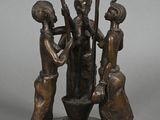 statue of three women with baseball bats and a bowl of water