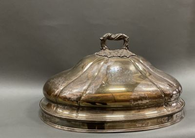 a silver plate with a bird on it on a table