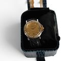 a watch that is in a black case on a white surface