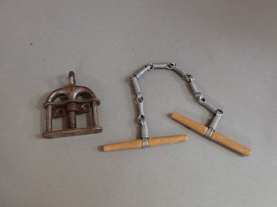 a small metal object with a wooden handle next to a small metal object with a wooden handle