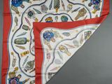 a close up of a red and white scarf with a design on it