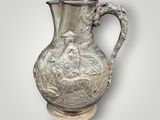 an image of a silver vase with a woman and a man on it