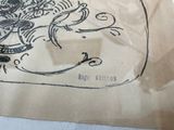 a drawing of a dragon on a piece of paper on a table