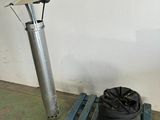 a bag on a pallet next to a metal pole