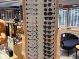many pairs of glasses on display in a store