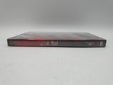 a dvd case with a red and black cover sitting on a white surface