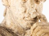 a statue of a man with a finger in his mouth